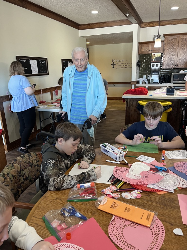 Students and seniors making valentines together