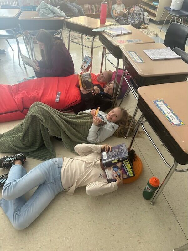students reading while on the floor