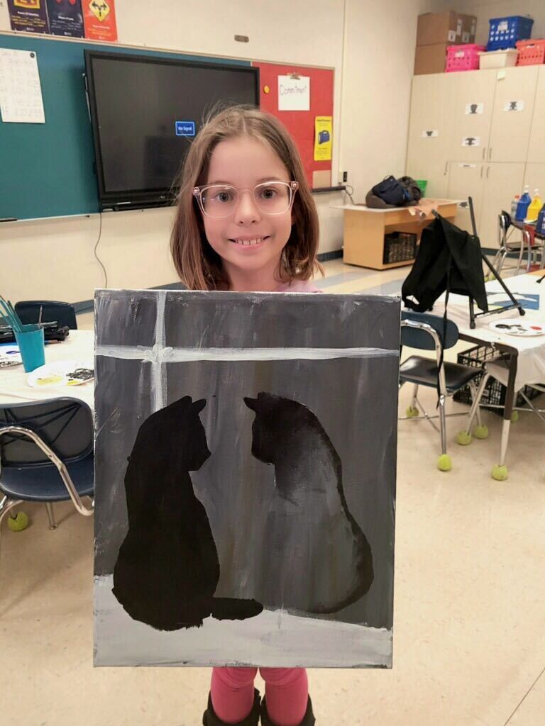 Student with painting of a cat