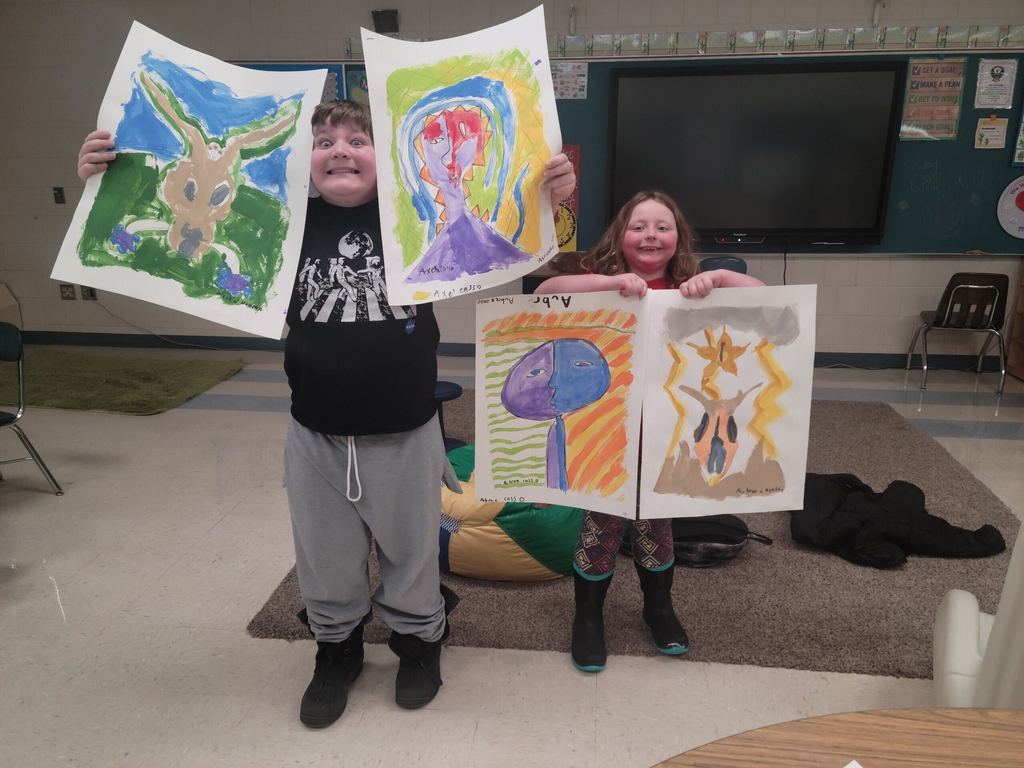 Students showing off paintings