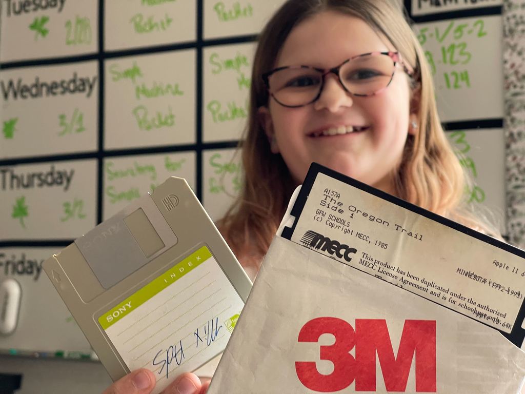 Student holding floppy disks