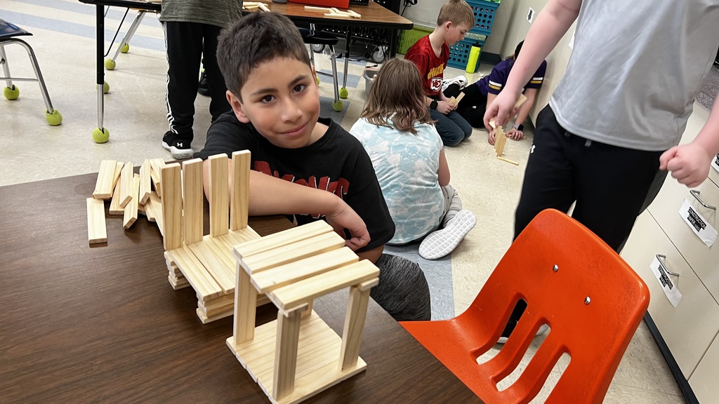 Student with table and chairs he built