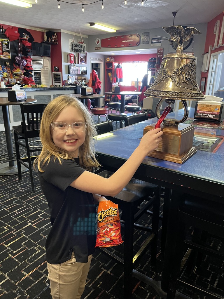 girl ringing a bell at bowling alley