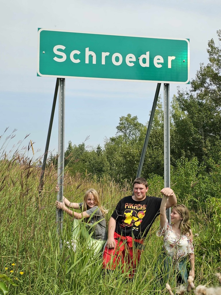 Kids by the schroeder sign